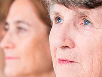 Three women of different ages are shown in profile, with the focus on the elderly woman in the foreground.