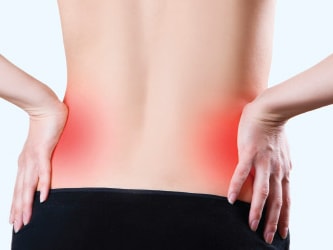 Person clutching sore lower back highlighted in red.