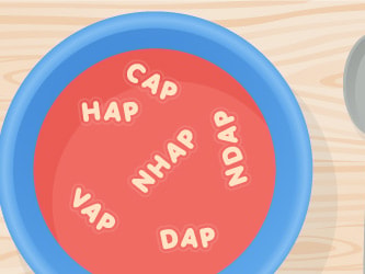 A blue bowl of alphabet soup displaying various letter combinations on a wooden surface, next to a spoon.