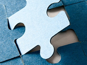 A blue puzzle piece fitting into place on a medbridge puzzle.