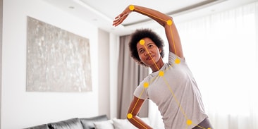 Individual doing a side stretch in a living room with posture alignment points, from medbridge.