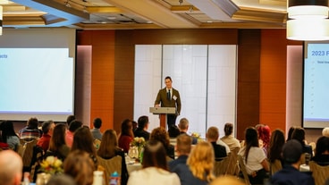 A speaker presents to an engaged audience in a conference room at a medbridge event.