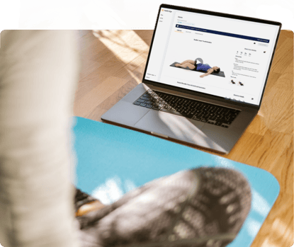 Person on a blue mat watches a medbridge healthcare training video of an instructor demonstrating a stretch.