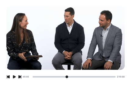 Three people conversing, including a woman with a tablet, while the medbridge video player is visible.