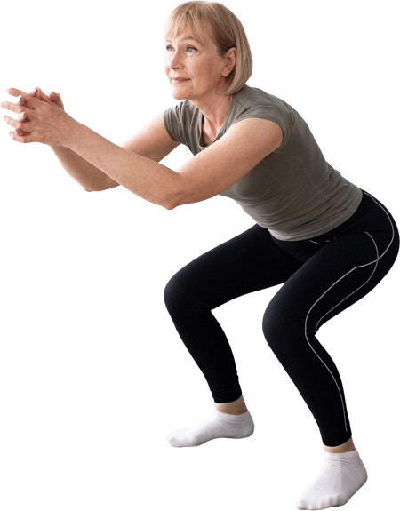 Older woman in a green shirt and black leggings doing squats for medbridge.