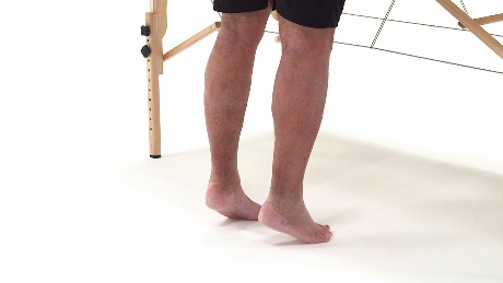 A person on tiptoes beside a wooden frame symbolizes the innovative reach of digital healthcare, like medbridge.