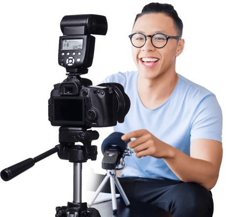 Person smiling while setting up camera gear and holding a microphone, highlighting essential skills for medbridge healthcare training.