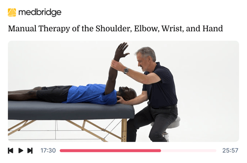 A therapist in a blue shirt provides shoulder therapy to a client on a table for medbridge.