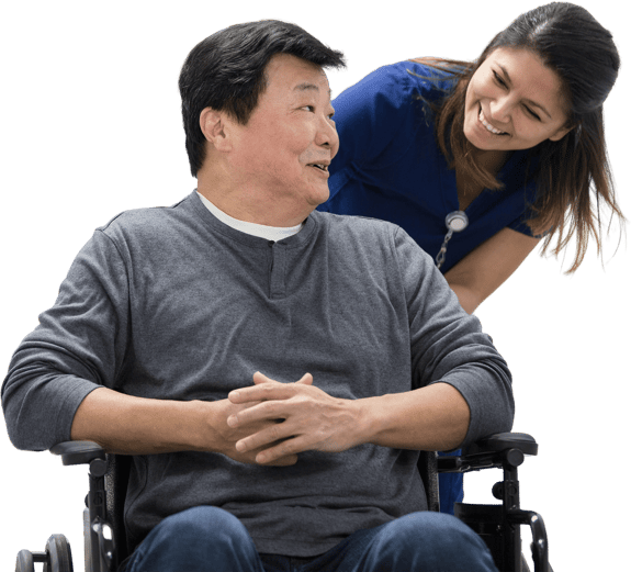 A man in a wheelchair smiles at a woman in a blue Medbridge uniform.