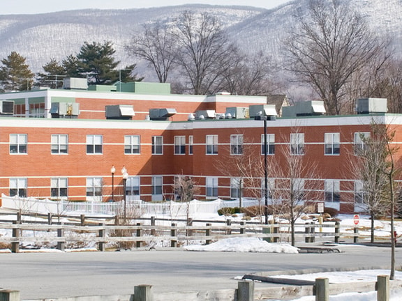 A rural critical access hospital in winter with snow-covered grounds, meeting critical access hospital requirements to serve remote communities.