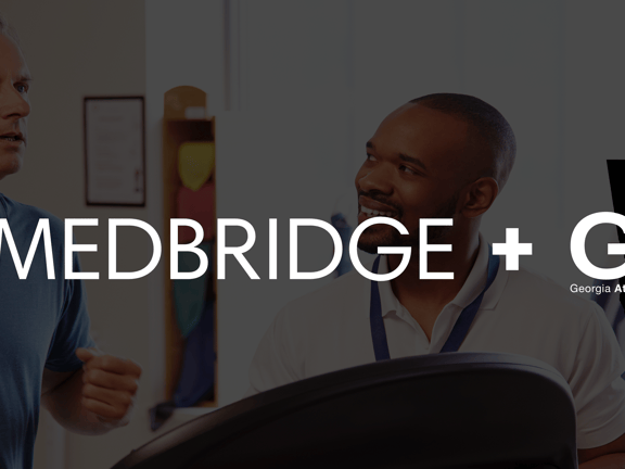 Two men talking with fitness equipment in front and medBridge and GATA logos visible.