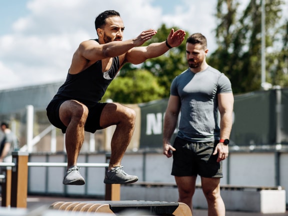 Two men in athletic gear exercise outdoors, highlighting physical activity for medbridge digital healthcare.