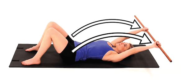 A person demonstrates a healthcare training technique with a wooden rod on a mat using Medbridge.