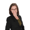 A smiling individual with glasses and shoulder-length brown hair, wearing a black blazer over a green top, is featured in a Medbridge professional portrait.