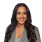 A smiling person with wavy brown hair and a plaid blazer against a white background, used for medbridge profile.