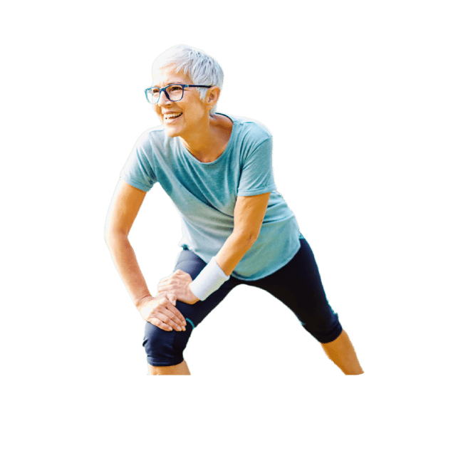 Older adult in glasses and a gray shirt smiling while stretching outdoors.