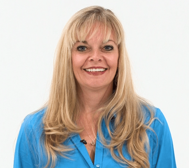 Woman with long blonde hair in a blue blouse smiling against a white background, representing medbridge.