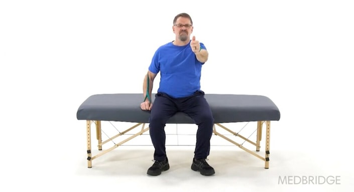 A man on a massage table gives a thumbs-up, highlighting how medbridge's hybrid care boosts his well-being.