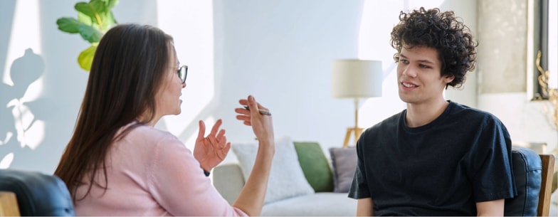A woman provides healthcare training to a young man during a Medbridge session.